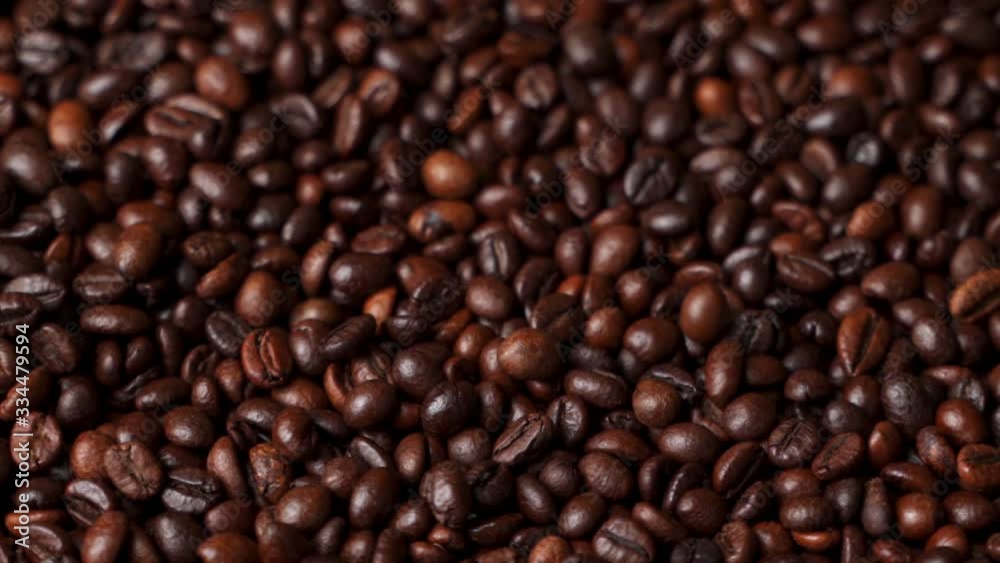 Close up of roasted brown coffee beans rotating
