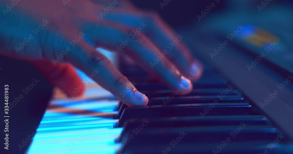 Close up of hands playing piano