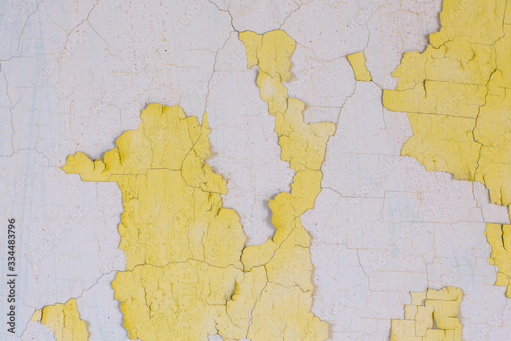 Obraz premium Weathering of old peeling paint. Vintage background for advertising and graffiti. Cracked paint texture. Design of a horizontal long banner with white and yellow cracked paint. 