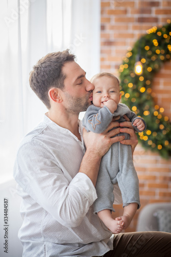 dad kisses his little son photo