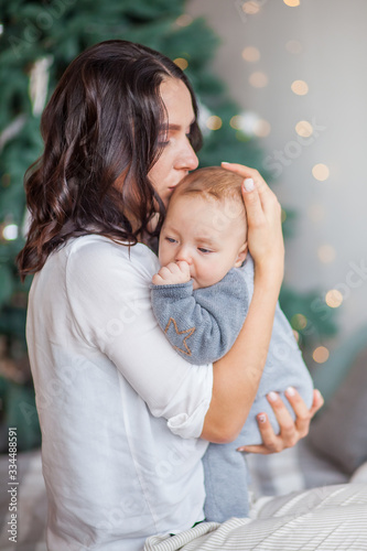 mom kisses a newborn baby