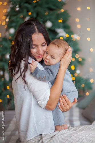 mom kisses a newborn baby