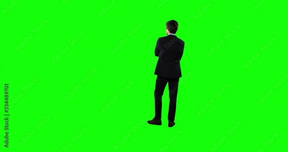 Rear view of a business man waiting with green screen Rear view of a business man waiting with green screen