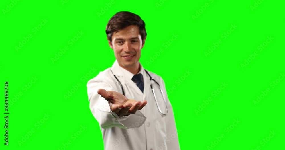 Front view of a doctor holding his hand for a copy space with green screen Front view of a doctor holding his hand for a copy space with green screen