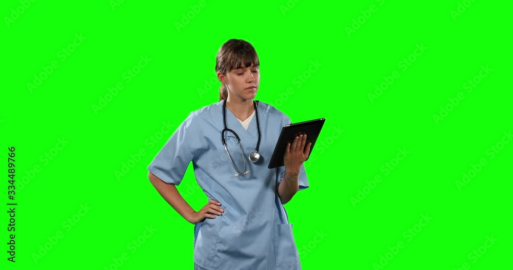 Front view of female doctor using her digital tablet with green screen Front view of female doctor using her digital tablet with green screen