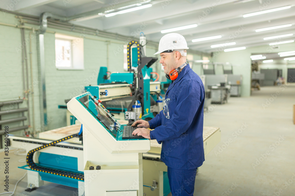 Worker in the Hard Hat Modern Factory CNC machine operator . Successful, Handsome Man in Modern Industrial Environment.Emotions, Copy Space Worker in the Hard Hat Modern Factory CNC machine operator . Successful, Handsome Man in Modern Industrial Environment.Emotions, Copy Space