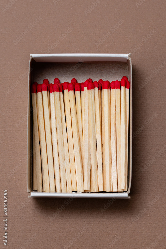matches in a cardboard box on a craft color background matches in a cardboard box on a craft color background