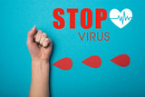 Top view of paper drops of blood near female fist on blue background, stop virus illustration