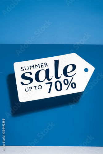 white big price tag with summer sale illustration on blue background