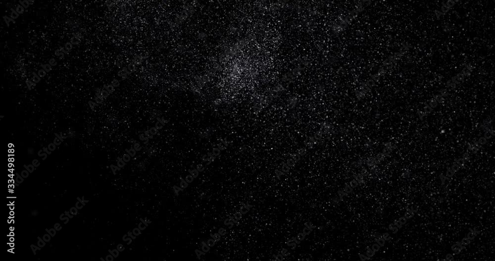 Flying dust particles on a black background Flying dust particles on a black background