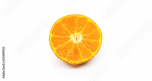 Half piece slice of fresh orange isolated on white background with clipping path. Fresh fruit on pastel color wall. Tropical  Summer and healthy food concept