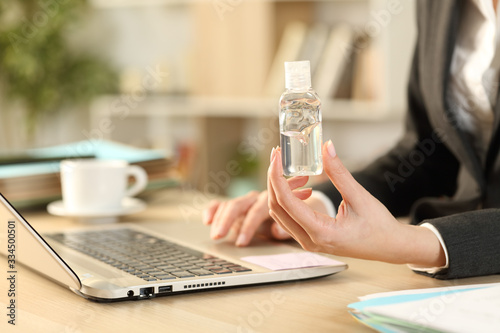 Entrepreneur hands using laptop showing sanitizer rub