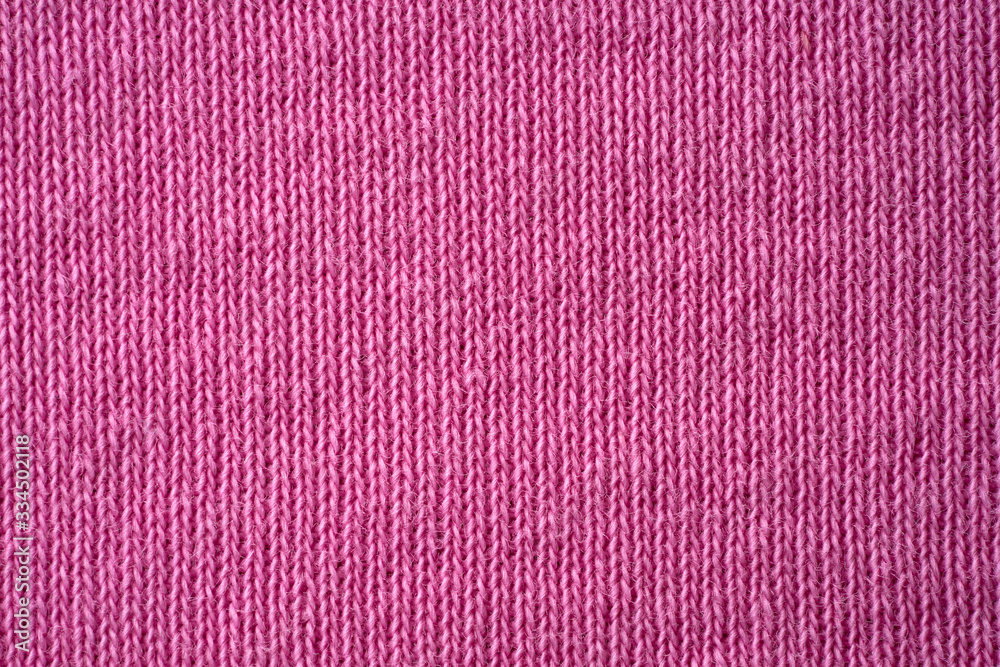 Closeup pink texture of woolen knitted fabric. Pattern of pink fabric. Closeup pink texture of woolen knitted fabric. Pattern of pink fabric.