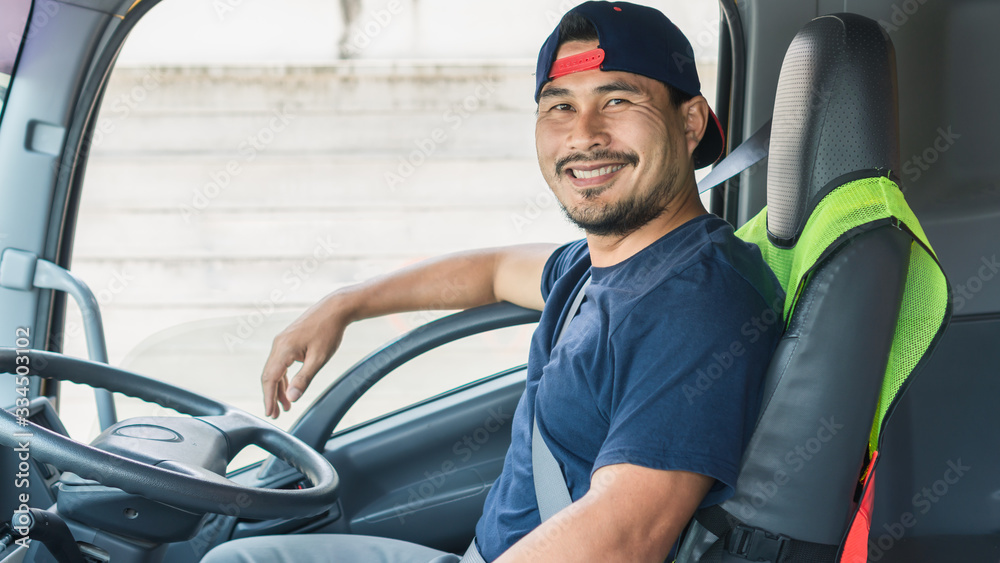 Happy smiling of professional truck driver asian man in a long transportation and delivery Happy smiling of professional truck driver asian man in a long transportation and delivery