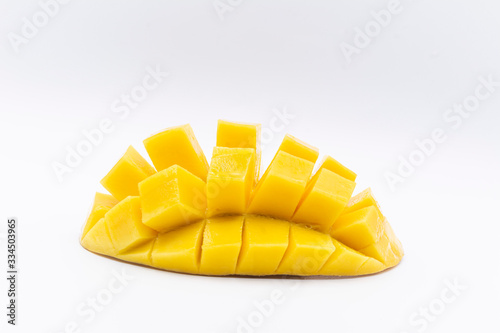 Yellow  mango slice with cubes isolated white background