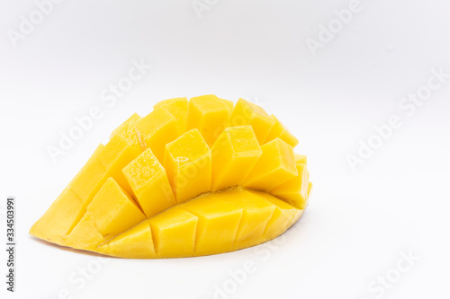 Yellow  mango slice with cubes isolated white background