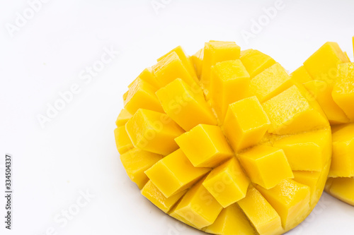 Yellow  mango slice with cubes isolated white background