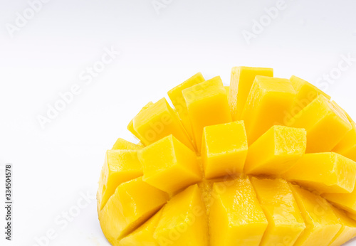 Yellow  mango slice with cubes isolated white background