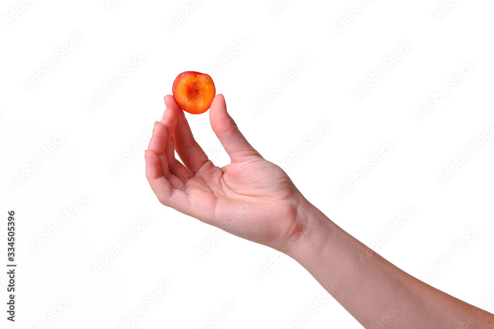 woman holds plum in hands on an isolated white background woman holds plum in hands on an isolated white background