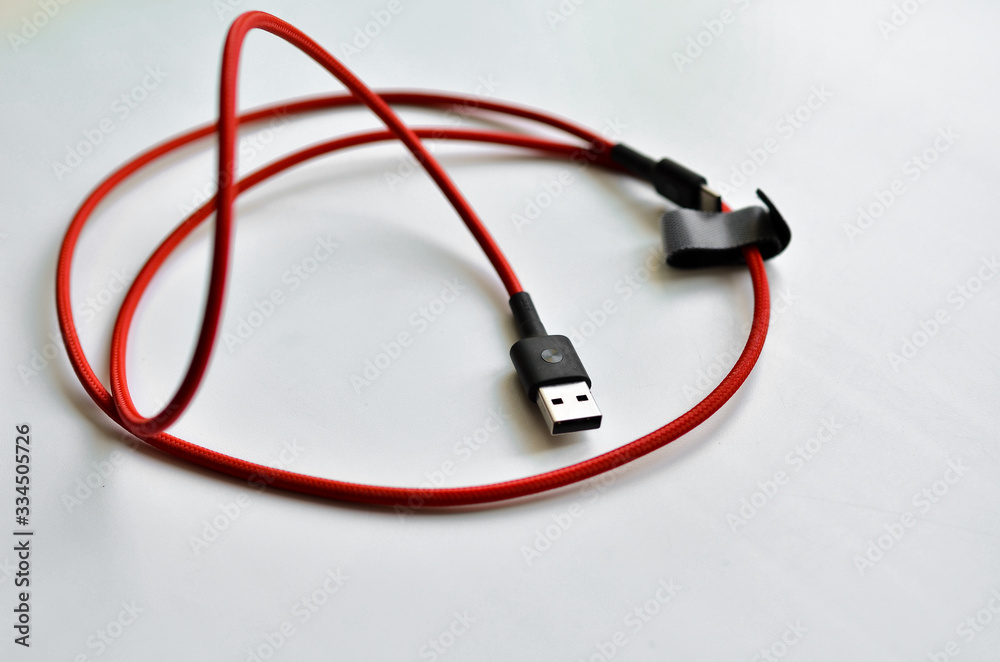 Universal charger for the phone, red cord. Universal charger for the phone, red cord.