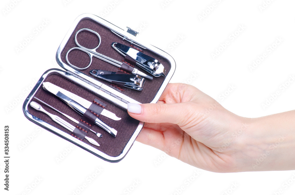 Hand holding manicure set in a case on white background isolation Hand holding manicure set in a case on white background isolation