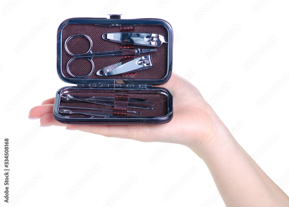 Hand holding manicure set in a case on white background isolation