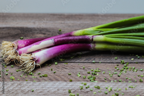  spring onions on a wooden table