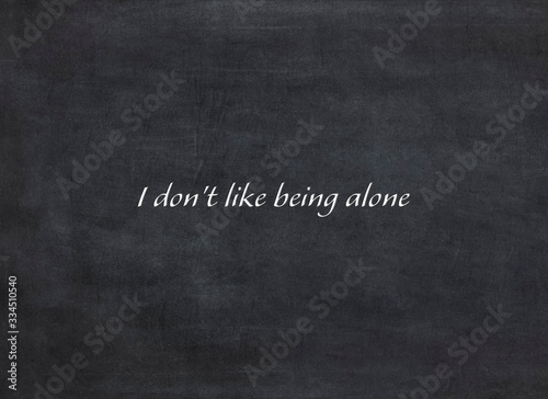 I don't like being alone written on a blackboard