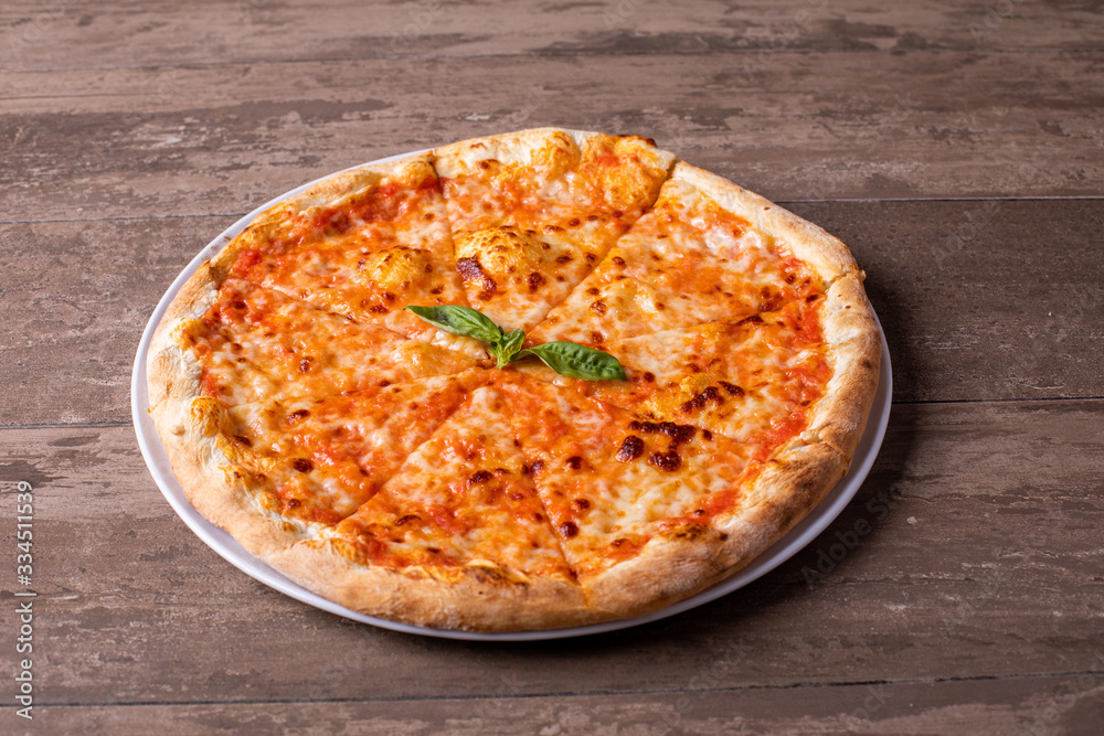 details of tasty margherita pizza on a table details of tasty margherita pizza on a table