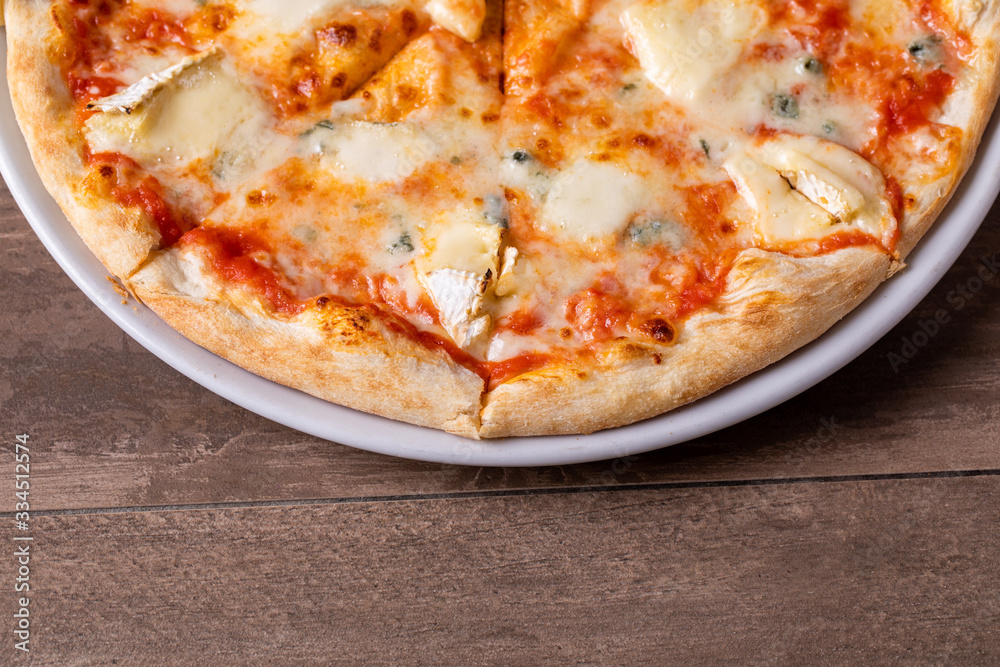 details of fresh four cheese pizza on wooden background