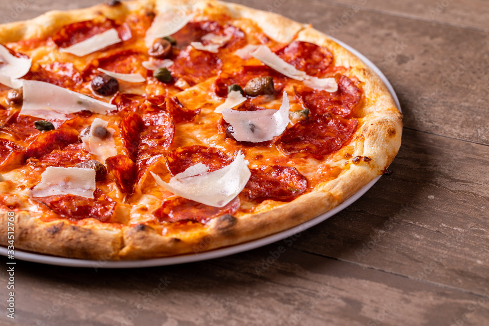 details of freshly baked salami pizza with olives and parmesan details of freshly baked salami pizza with olives and parmesan