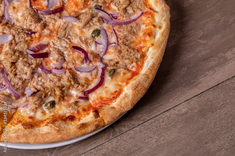 details of tasty tuna pizza with red onions