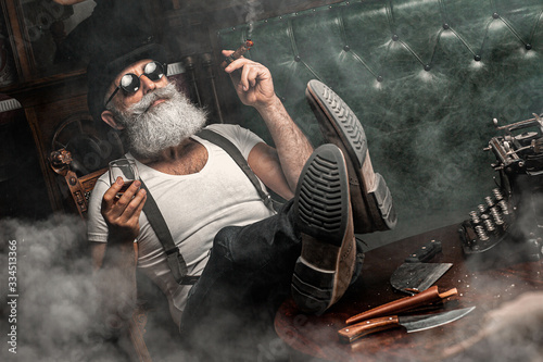 Canvas Print Old man smoking a cigar indoors