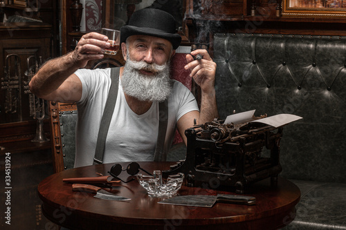 Canvas Print Old man smoking a cigar indoors