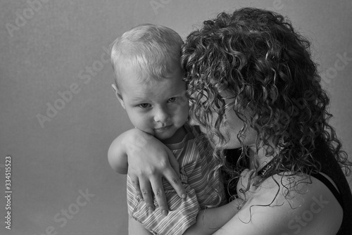 Frightened mother hugs her little son, the theme of domestic violence.