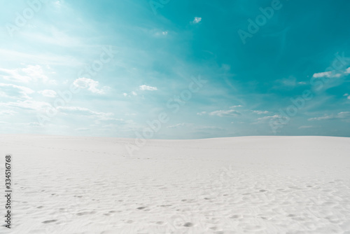 beautiful clean beach with white sand and blue sky with white clouds