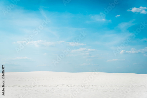 beautiful clean beach with white sand and blue sky with white clouds © LIGHTFIELD STUDIOS