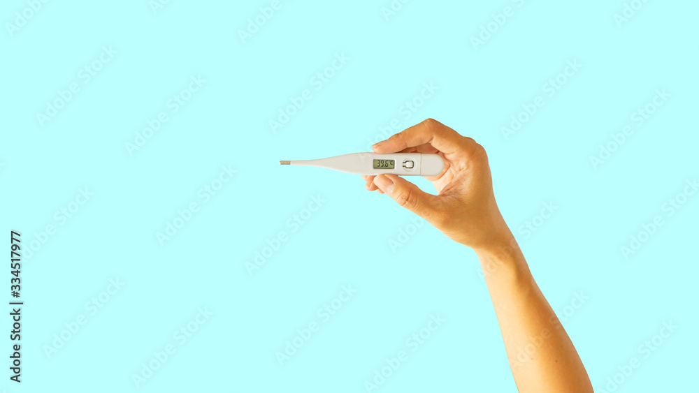 A person hand holding thermometer to check temperature for fever 39.6 degree celsius, human body part isolated die cut on blue background with clipping path A person hand holding thermometer to check temperature for fever 39.6 degree celsius, human body part isolated die cut on blue background with clipping path