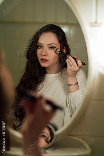Close up portrait. Women make up eyes, lips at home by the mirror