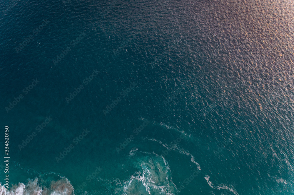 View from a drone to a cape and Pacific coast at sunset