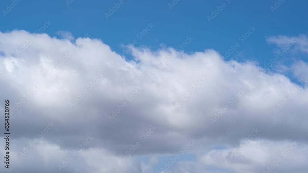 Video timelapse of beautiful white fluffy clouds moving fast in blue sky blowing by strong wind. Natural background. Video timelapse of beautiful white fluffy clouds moving fast in blue sky blowing by strong wind. Natural background.