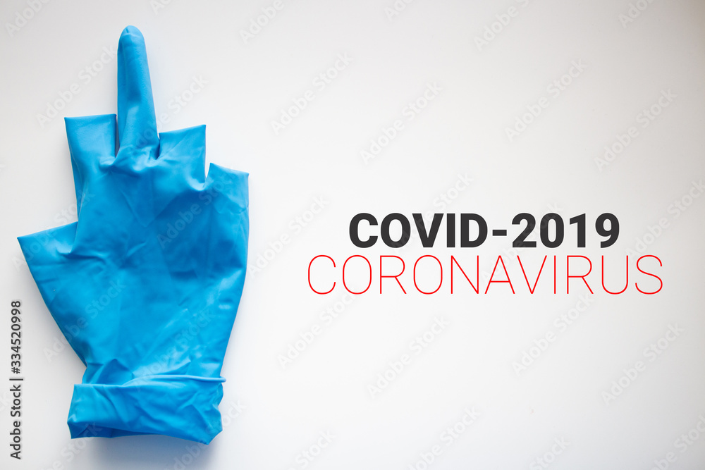 Blue glove with middle finger. stop the coronavirus. covid-19.