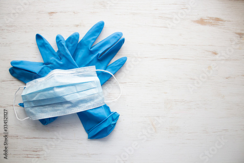Blue medical gloves and face mask on a scratched grunge background. stop the coronavirus. cavid-19.