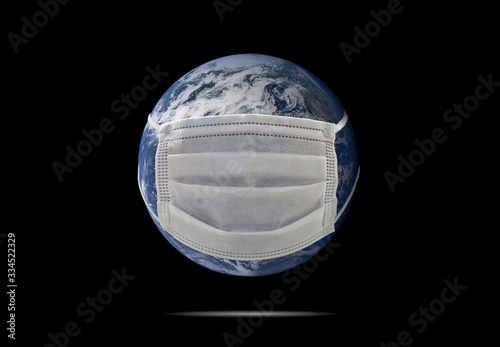 On planet earth, a medical mask to protect against the coronavirus epidemic. Concept of a global virus epidemic, concept of Corona virus quarantine, Covid-19. Elements of this image furnished by NAZA photo