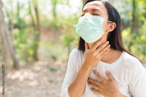 asian middle-aged women get wearing hygienic mask prevent from flu, allergy symptoms coughing. sick mature woman with sore throat, virus PM2.5, Coronavirus, (2019-nCoV). healthcare and medical concept
