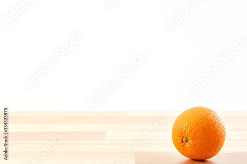 Fresh orange fruit on wooden table isolated
