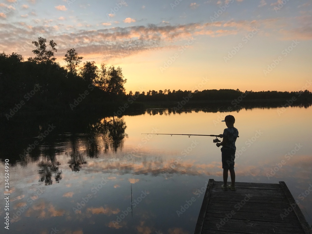 silhouette of fisherman at sunset