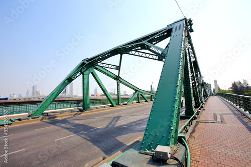 A beautiful old green bridge with steel structures.