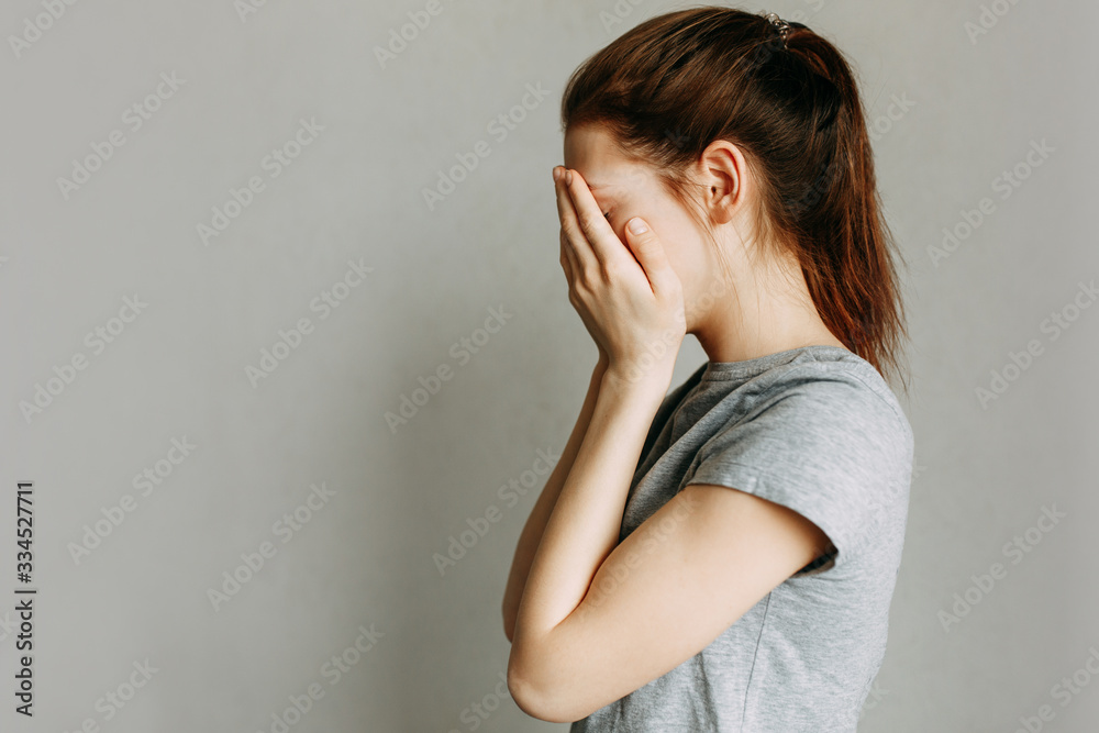 Stop domestic violence against women. The girl covers her face with her hands and cries. Stop domestic violence against women. The girl covers her face with her hands and cries.