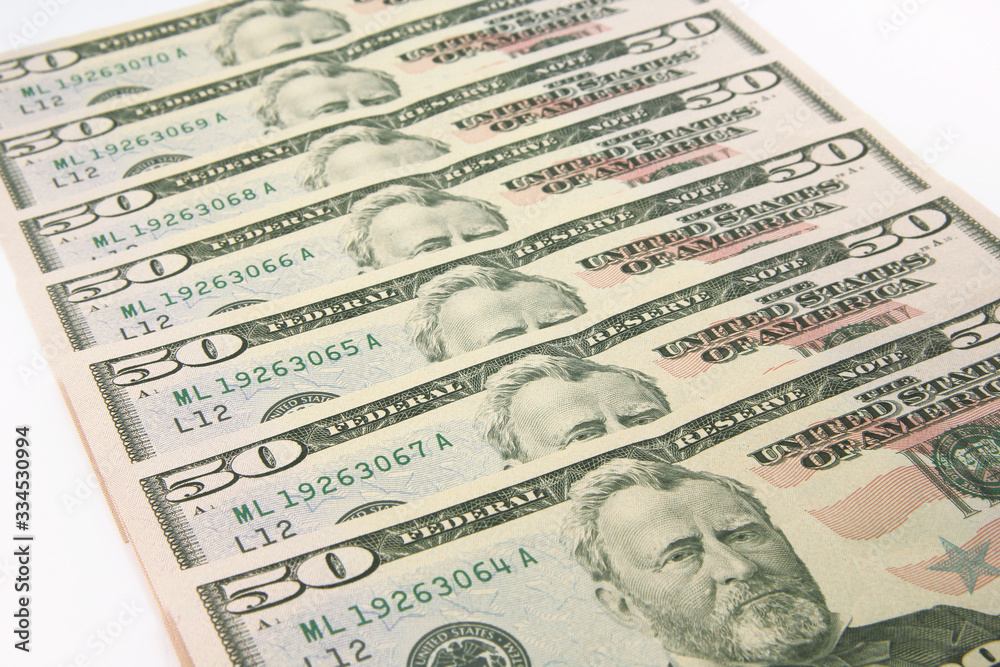Stack of american money, fifty dollar cash banknotes on white background Stack of american money, fifty dollar cash banknotes on white background